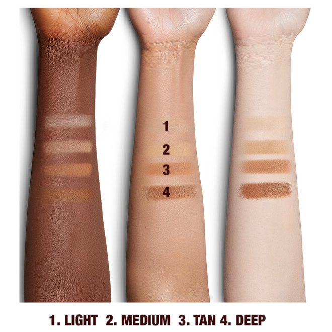 Deep, tan, and fair-tone arms with swatches of pressed powder in light, medium, tan, and deep. 