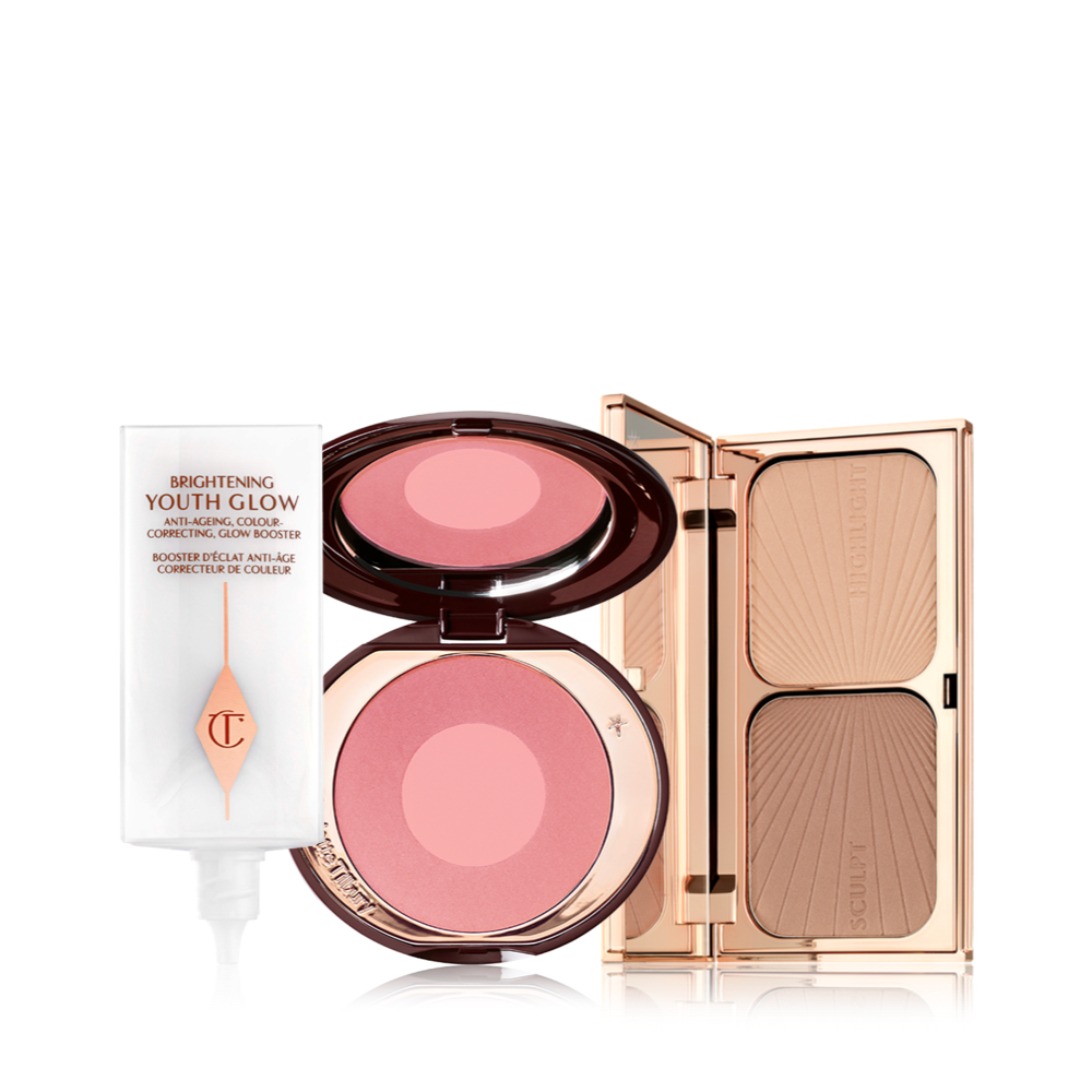 Glowy primer in a white-coloured bottle, duo blush compact in medium pink and pearlescent pink with a mirrored lid, and duo contour compact with a mirrored lid in gold-coloured packaging.
