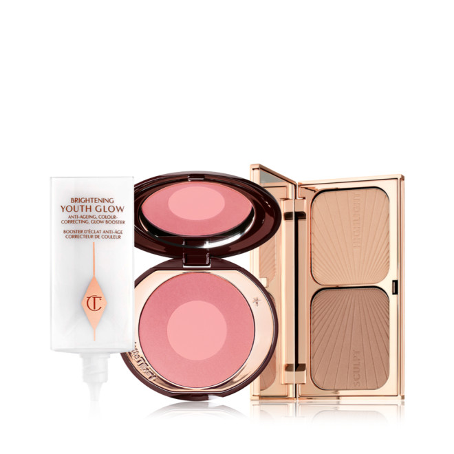 Glowy primer in a white-coloured bottle, duo blush compact in medium pink and pearlescent pink with a mirrored lid, and duo contour compact with a mirrored lid in gold-coloured packaging.