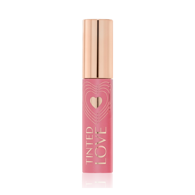 A closed lip and cheek tint with a gold-coloured lid in a soft nude pink-coloured tube.