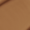 Close-up swatch of a skin-like, glowy foundation in a dark brown shade.