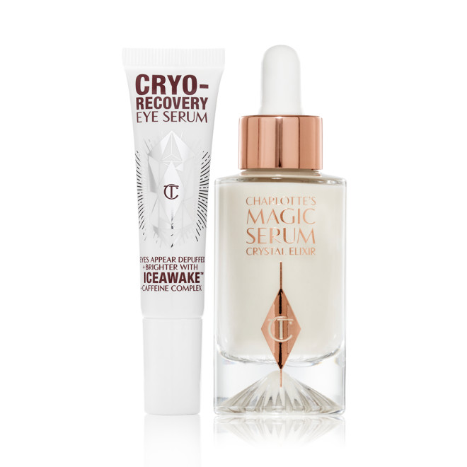 Eye serum in a white-coloured tube with geometric patterns on the front in a reflective, silver colour along with luminous, facial serum in a glass bottle with a white and gold dropper lid.