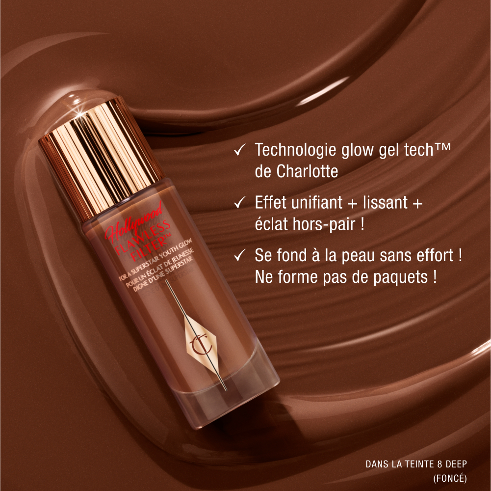 Charlotte Tilbury Hollywood Flawless Filter bottle with gold cap on a chocolate-brown background, promoting glow gel technology that blurs, smooths, and glows, featuring shade 8 Deep.