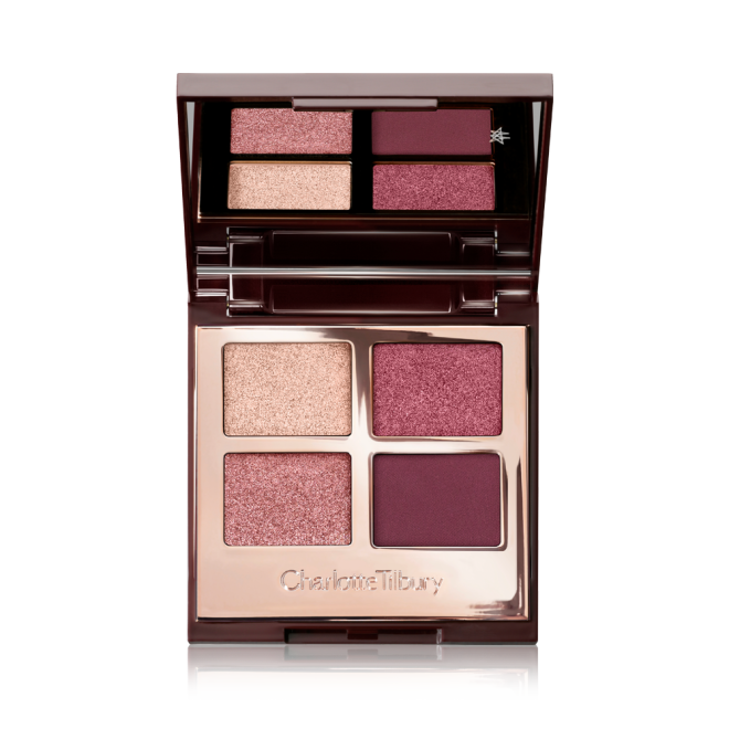 A mirrored-lid, quad eyeshadow palette with eyeshadows in shades of pink, plum, and champagne. 