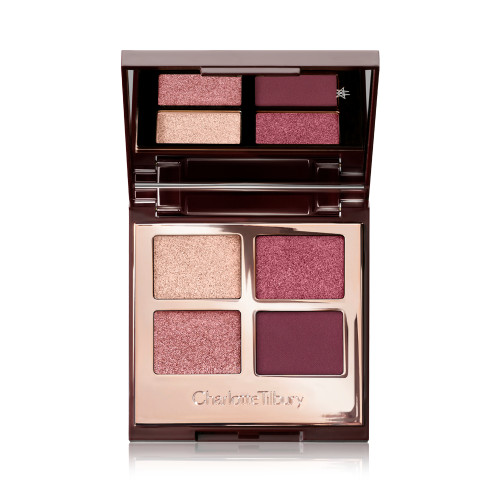 A mirrored-lid, quad eyeshadow palette with eyeshadows in shades of pink, plum, and champagne. 