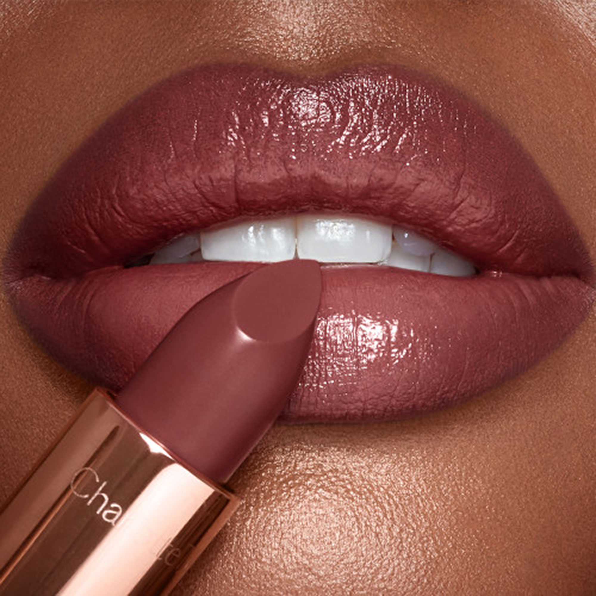 Model wearing Pillow Talk Intense brown-pink lipstick