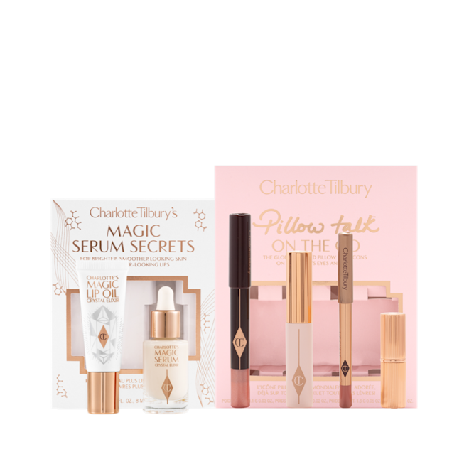 Travel-size facial serum and lip oil in a white-coloured gift box and a nude pink chubby eyeshadow stick, black mascara, lip liner pencil in vivid pink, and matte lipstick in a pink-coloured gift box, perfect for traveling.