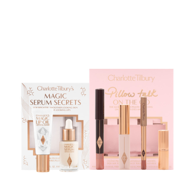 Travel-size facial serum and lip oil in a white-coloured gift box and a nude pink chubby eyeshadow stick, black mascara, lip liner pencil in vivid pink, and matte lipstick in a pink-coloured gift box, perfect for traveling.