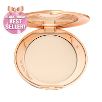 An open, pressed powder compact in a cream colour. 