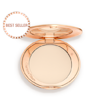 An open, pressed powder compact in a cream colour. 