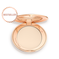 An open, pressed powder compact in a cream colour. 