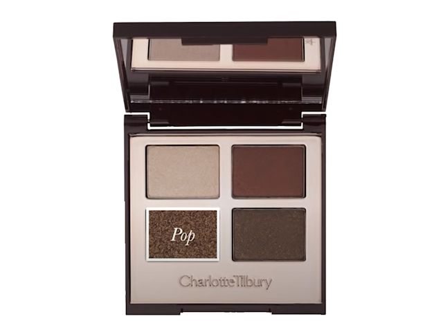 An open, mirrored-lid quad eyeshadow palette with eyeshadows in shades of shimmery brown, dark brown, grey-brown, and dark beige, with pop written on the shimmery brown shade. 
