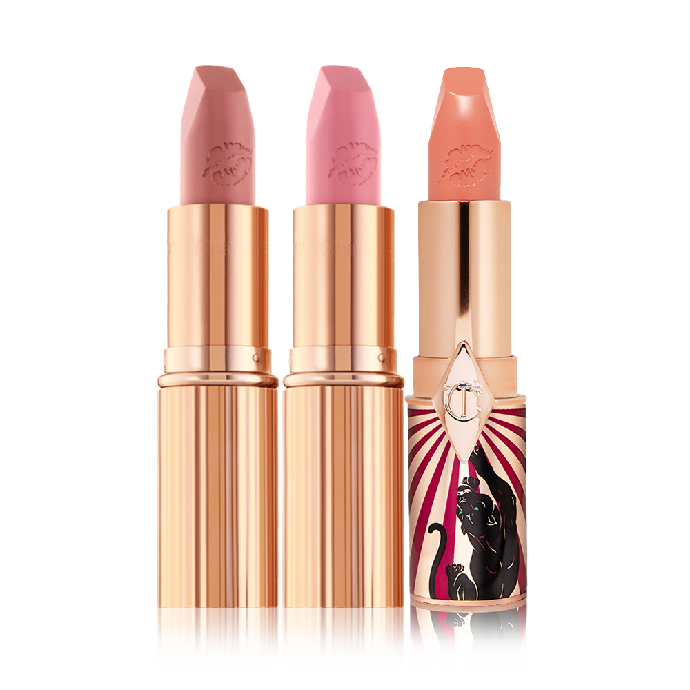 Three open lipsticks, two matte lipsticks in nude shades of brown and pink and a satin-finish lipstick in a light coral shade.