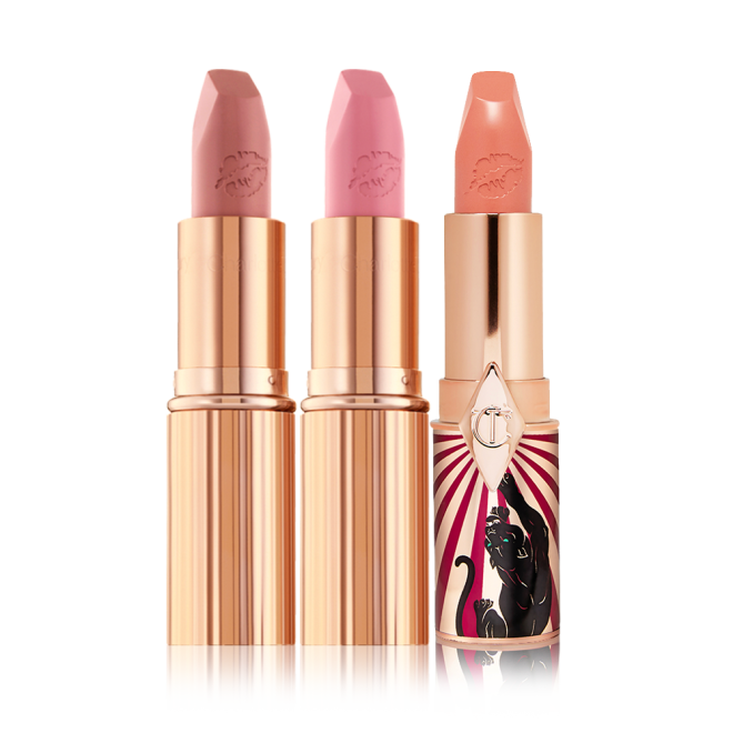 Three open lipsticks, two matte lipsticks in nude shades of brown and pink and a satin-finish lipstick in a light coral shade.