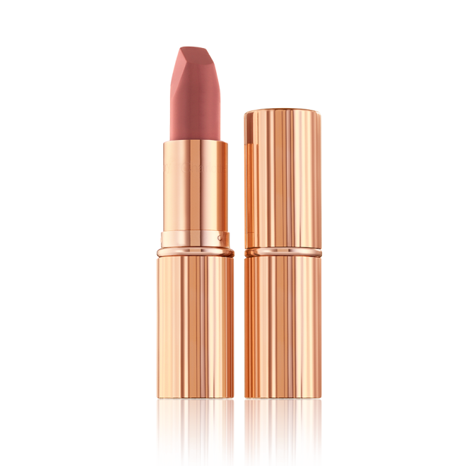 Two lipsticks, with and without lid, in a mid-toned muted nude-rose matte shade, in sleek, gold-coloured tubes. 