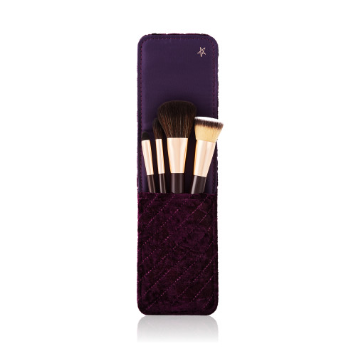 An open makeup clutch brush gift set in brown colour, which includes a foundation brush, powder brush, an eyeshadow brush, and bronzing brush. 