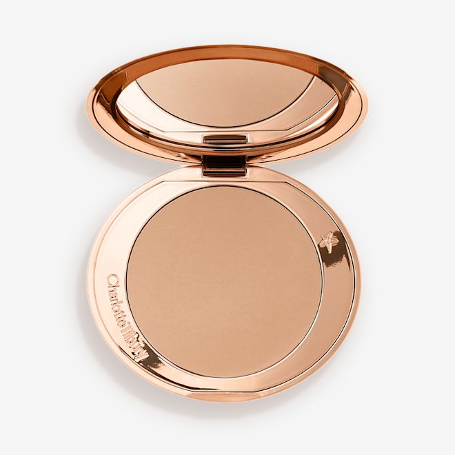 Airbrush Bronzer in Fair open An open mirrored-lid bronzer compact in a light shade.