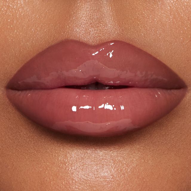 Close up of model wearing Pillow Talk Big Lip Plumpgasm lip gloss