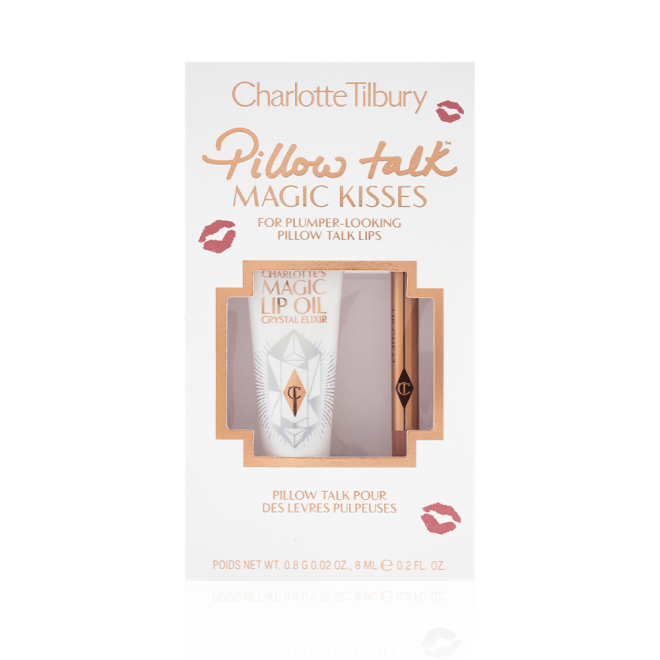 Lip oil in a white-coloured tube with a gold-coloured lid along with a lip liner pencil in a nude pink shade in a white packaging box text on it that reads, 'Pillow Talk Magic Kisses'