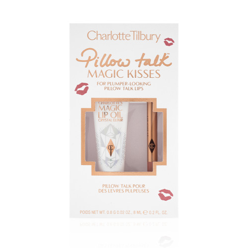 Lip oil in a white-coloured tube with a gold-coloured lid along with a lip liner pencil in a nude pink shade in a white packaging box text on it that reads, 'Pillow Talk Magic Kisses'