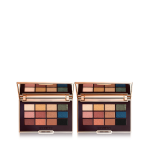 Two open, mirrored-lid eyeshadow palettes with nude brown, green, blue, black, gold, and pink shades.