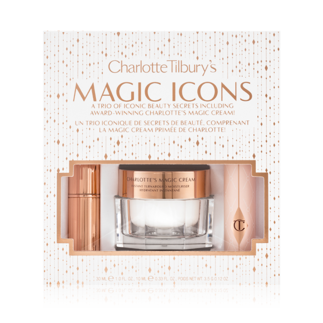 Pearly-white face cream in a glass jar with a gold-coloured lid, black mascara in a pink tube with a gold-coloured lid, and matte lipstick in a gold-coloured tube packed inside a white-coloured gift box with the text, 'Charlotte Tilbury's Magic Icons' written on it in reflective, gold colour. 