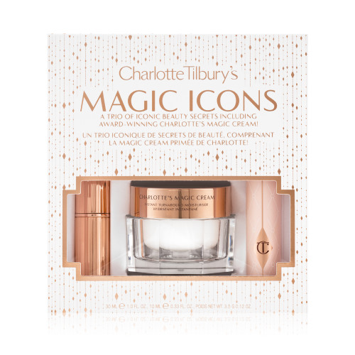Pearly-white face cream in a glass jar with a gold-coloured lid, black mascara in a pink tube with a gold-coloured lid, and matte lipstick in a gold-coloured tube packed inside a white-coloured gift box with the text, 'Charlotte Tilbury's Magic Icons' written on it in reflective, gold colour. 
