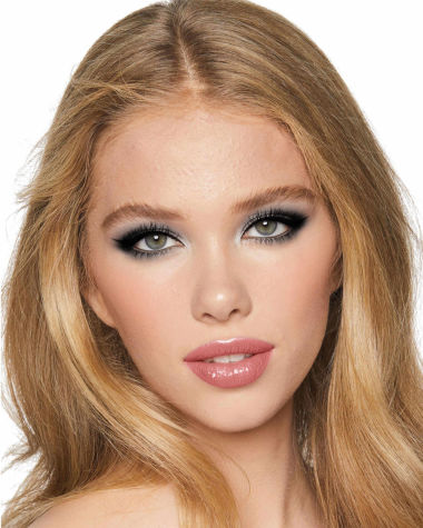 A fair-tone model with grey eyes wearing smokey silvery eyeshadow with bronzed cheeks and glossy nude-peach lips. 