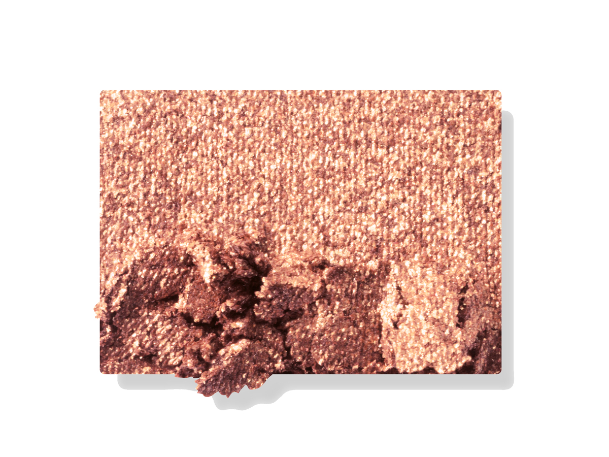 Swatch of a shimmery bronze-gold eyeshadow. 
