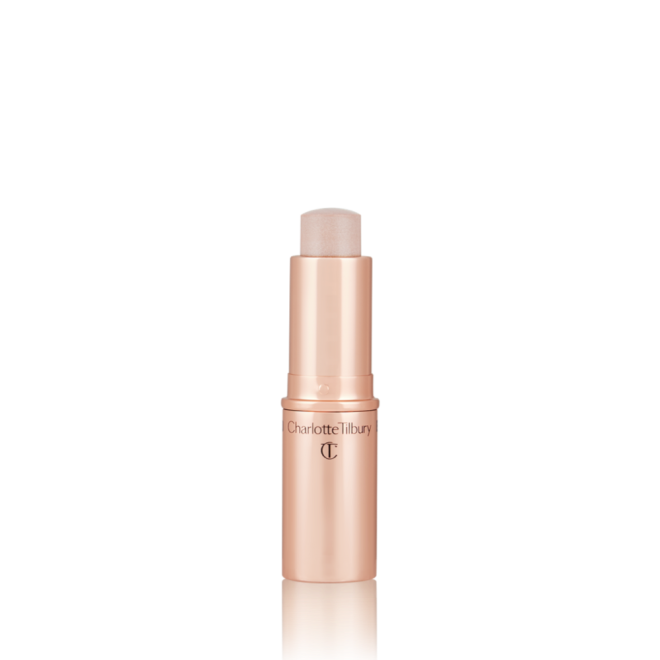 An open, highlighter stick in soft opal colour with a golden-coloured tube.