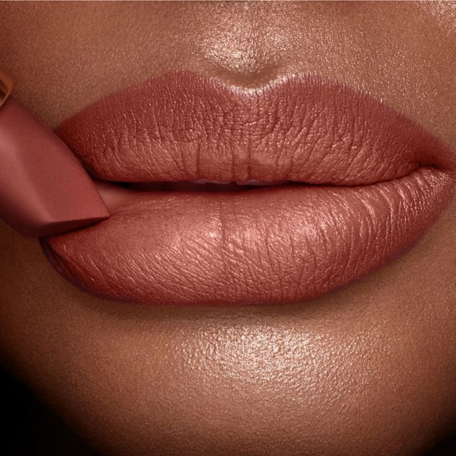Model wearing Hot Gossip and Super Fabulous lip liner and lipstick combination