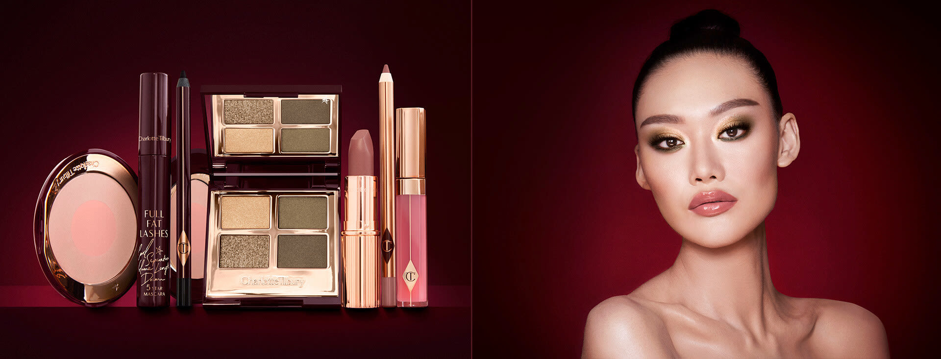 A fair-tone model with brown eyes wearing smokey green eye makeup with black eyeliner, soft brown blush, and nude brown lipstick, along with a quad eyeshadow palette in shades of green and gold, a brown eyeliner pencil, mascara, an open two-tone blush in nude pink, a warm pink lip liner pencil, a warm rose lipstick, and a bright pink lip gloss. 