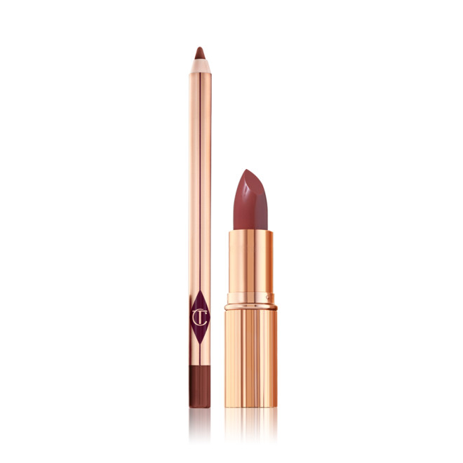 An open rose-pink lip liner pencil and open rose-pink lipstick, both in the iconic, golden, Charlotte Tilbury packaging. 
