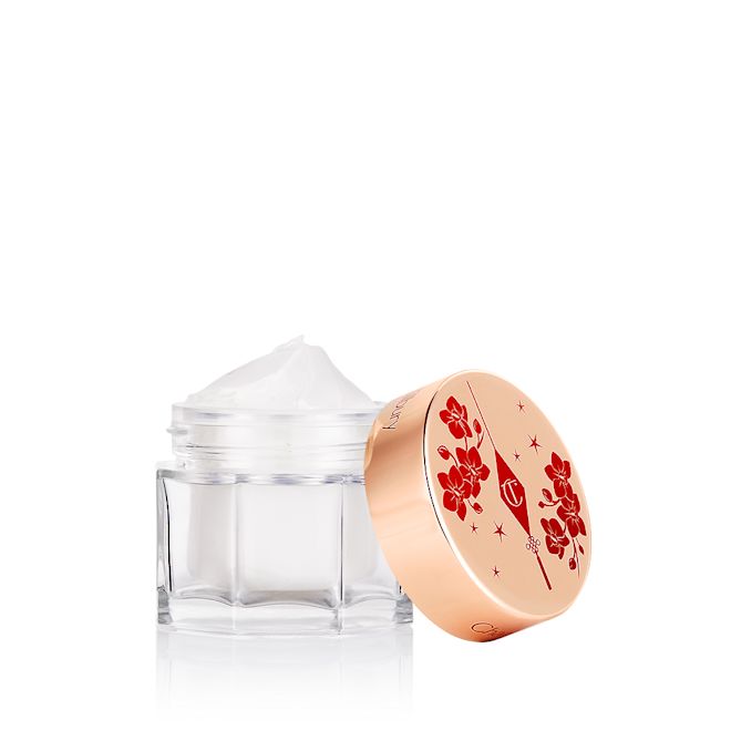 Lunar New Year Magic Cream open Pearly-white cream in a glass jar with a gold-coloured lid with red-coloured tiger stripes illustrated all over for the Lunar New Year.
