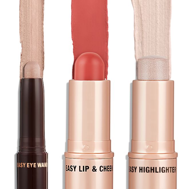 Quick & Easy Instant 5 Minute Pretty Fresh Look Kit products displayed An open shadow stick in a shimmery champagne pink shade, a lip and cheek blush stick in a rich coral shade, and highlighter stick in an opal shade.