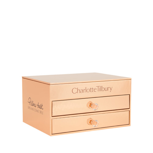 A makeup and skincare vault in the shape of a chest of drawers in gold-colour with sparkly handles on the drawers.