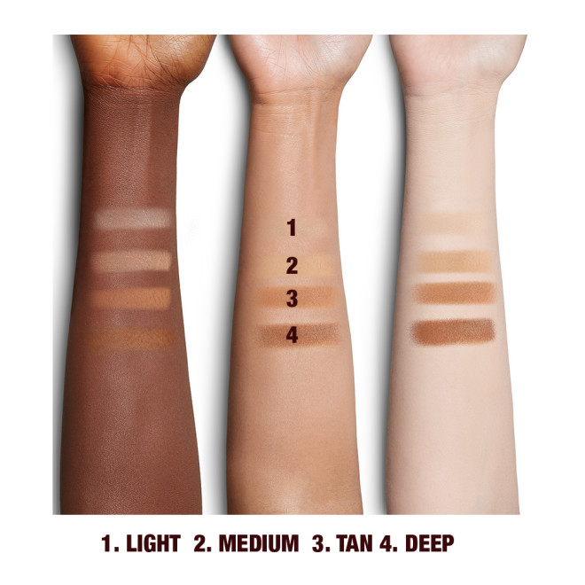 Deep, tan, and fair-tone arms with swatches of pressed powder in light, medium, tan, and deep. 