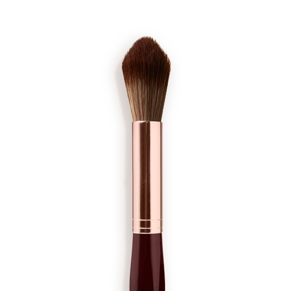 Close-up of a powder brush with brown-coloured bristles with a rose-gold and dark crimson handle. 