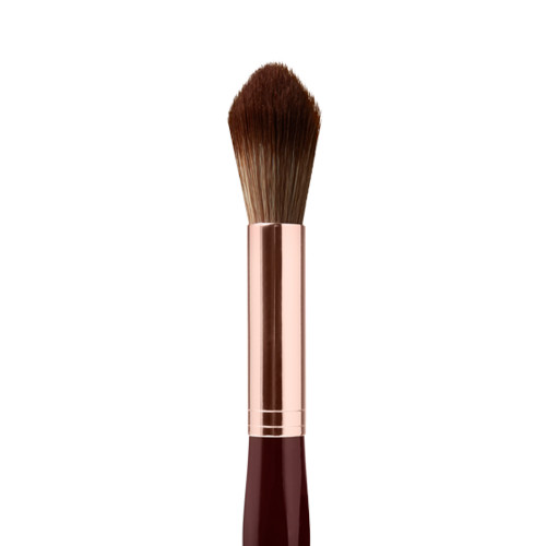 Close-up of a powder brush with brown-coloured bristles with a rose-gold and dark crimson handle. 