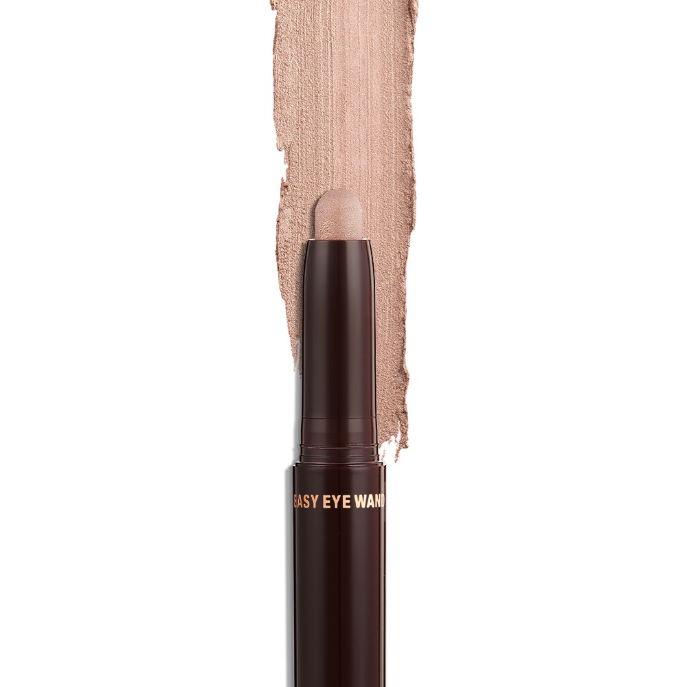 An open, cream eyeshadow wand in a champagne pink shimmer shade.