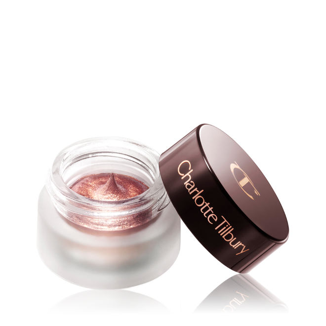 A shimmery, dark rose gold cream eyeshadow in an open glass pot with a dark brown-coloured lid. 