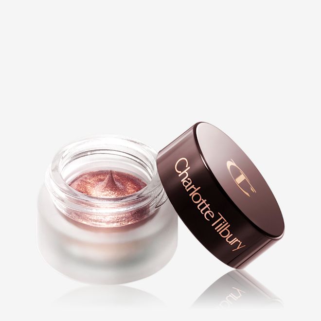 Eyes to Mesmerise in Sunset Rose open A shimmery, dark rose gold cream eyeshadow in an open glass pot with a dark brown-coloured lid.