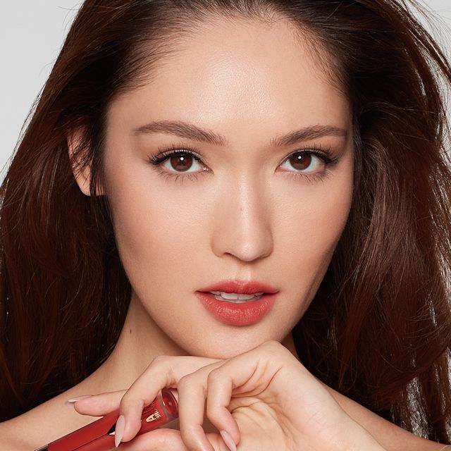 Model wearing a classic red lip evening makeup look using Airbrush Flawless Lip Blur