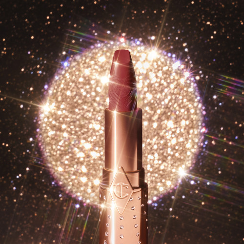 An open, satin finish lipstick in a rose pink shade with gold-coloured tube. 