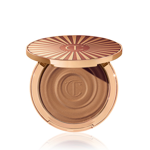 Open, cream bronzer compact in a light-sandy-brown shade with gold-coloured packaging.