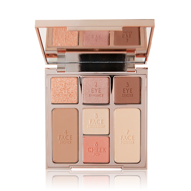 An open, mirrored-lid face palette with nude eyeshadows, nude pink and soft pink blushes, bronzer, and highlighter. 