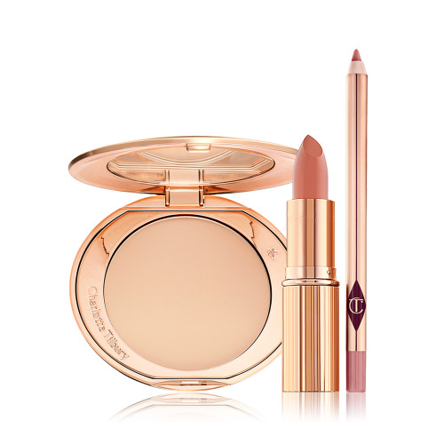 An open, mirrored-lid powder compact in a light shade, an open lipstick in a nude peach shade, and an open lip liner pencil in a warm pink shade.