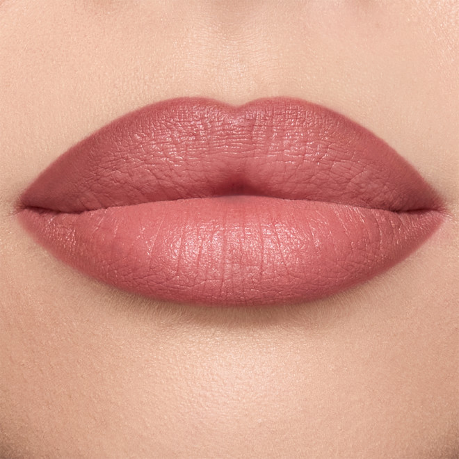 Model wearing Pillow Talk Medium Lip Cheat berry-pink lip liner