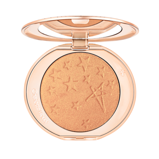 An open highlighter powder compact in a true gold shade with a mirrored lid.