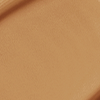 Close-up swatch of a skin-like, glowy foundation in a medium-brown shade.